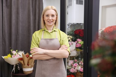 Business owner with crossed arms in her flower shop