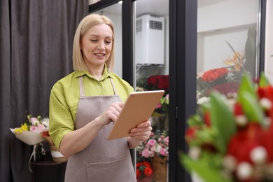 Business owner with tablet in her flower shop