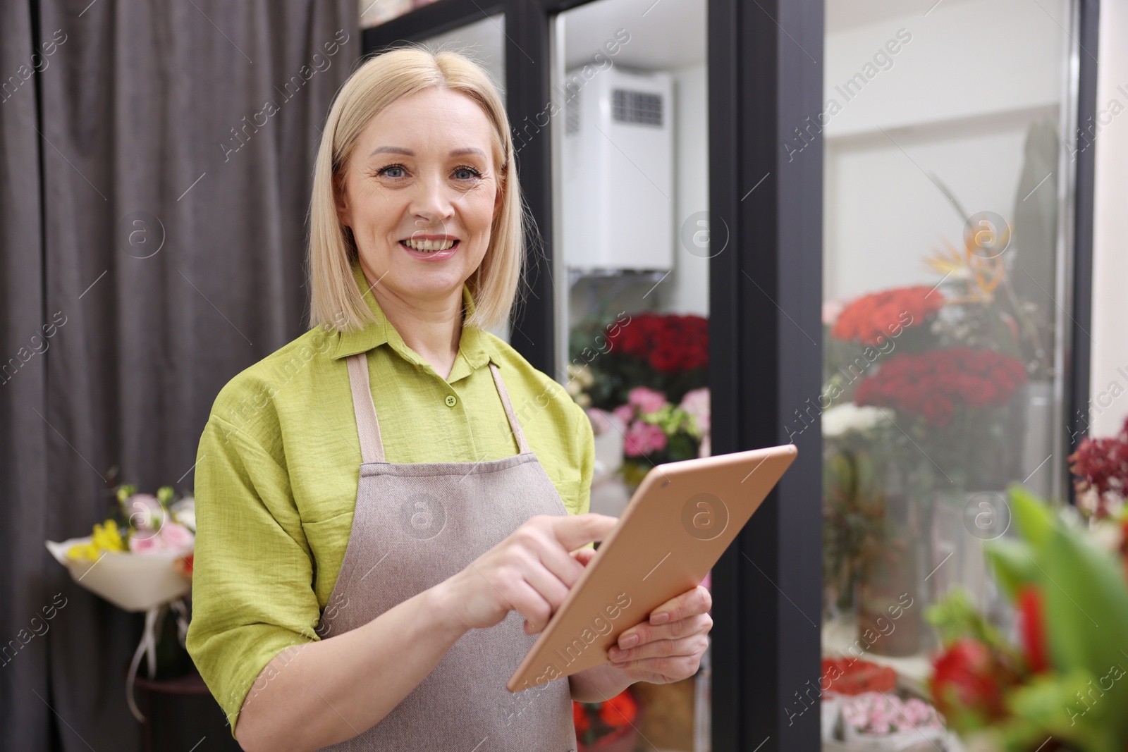 Photo of Business owner with tablet in her flower shop