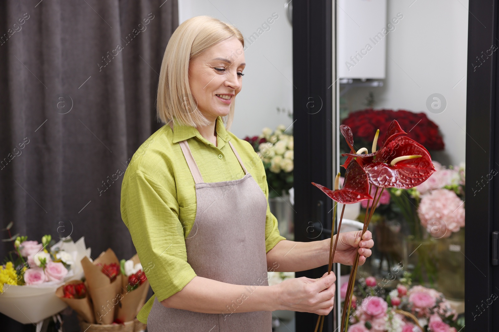 Photo of Business owner with anthurium flowers in her shop