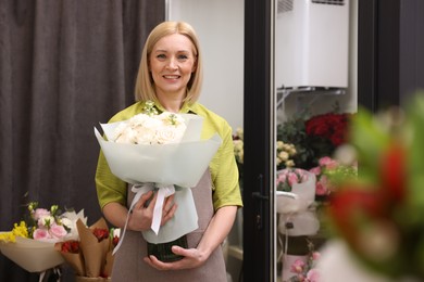 Photo of Business owner with beautiful bouquet in her flower shop