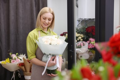 Photo of Business owner with beautiful bouquet in her flower shop