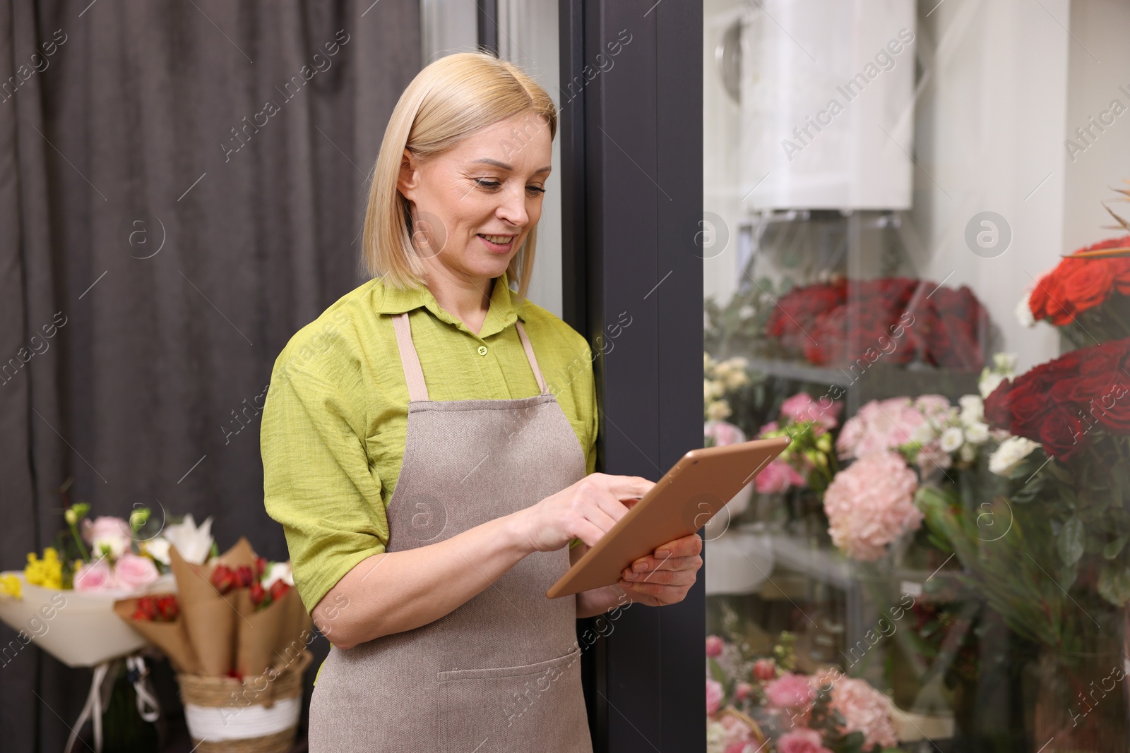 Photo of Business owner with tablet in her flower shop