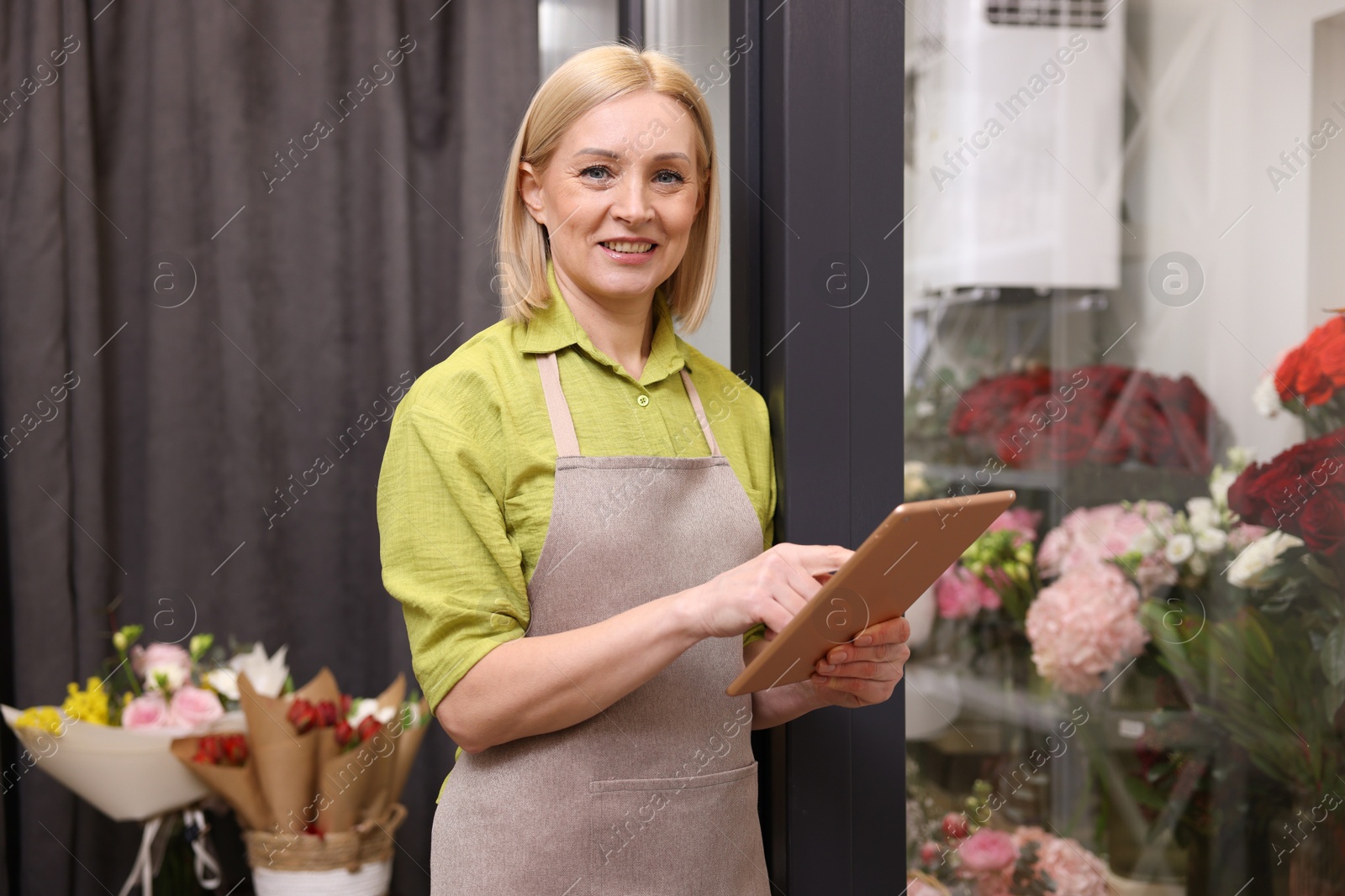 Photo of Business owner with tablet in her flower shop