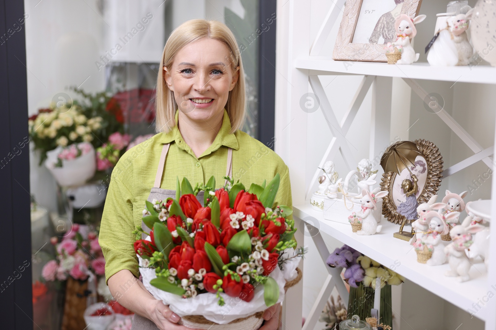 Photo of Business owner with beautiful bouquet in her flower shop