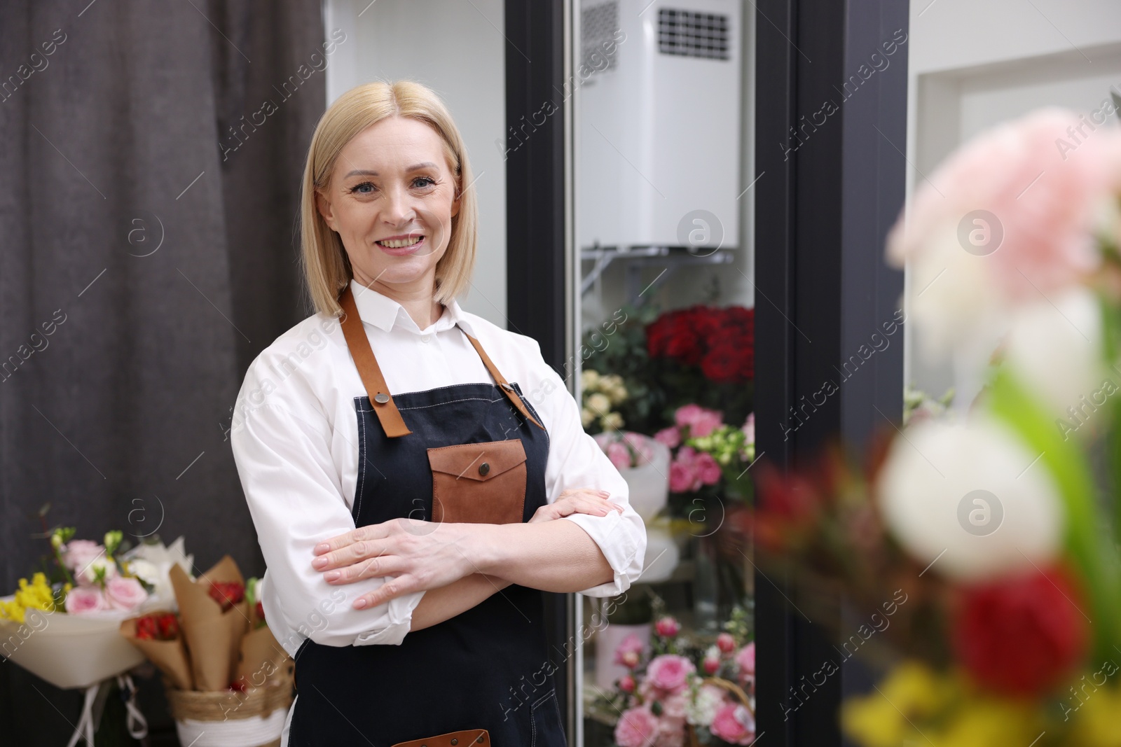 Photo of Business owner with crossed arms in her flower shop