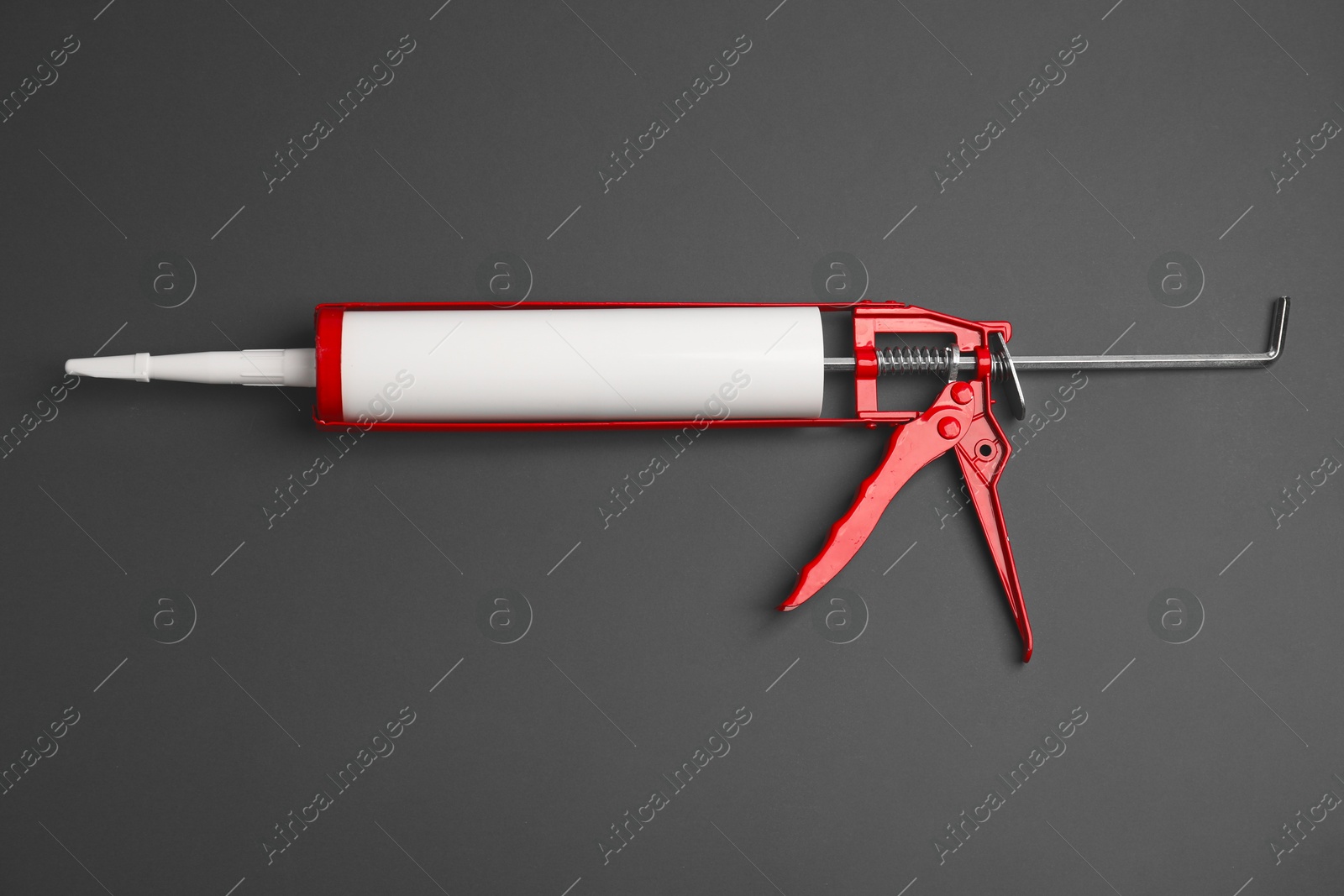 Photo of One glue gun on gray background, top view