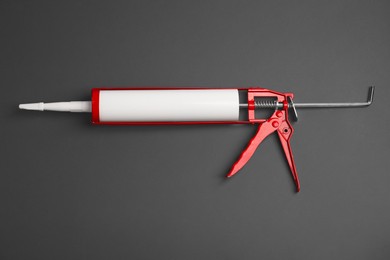 Photo of One glue gun on gray background, top view