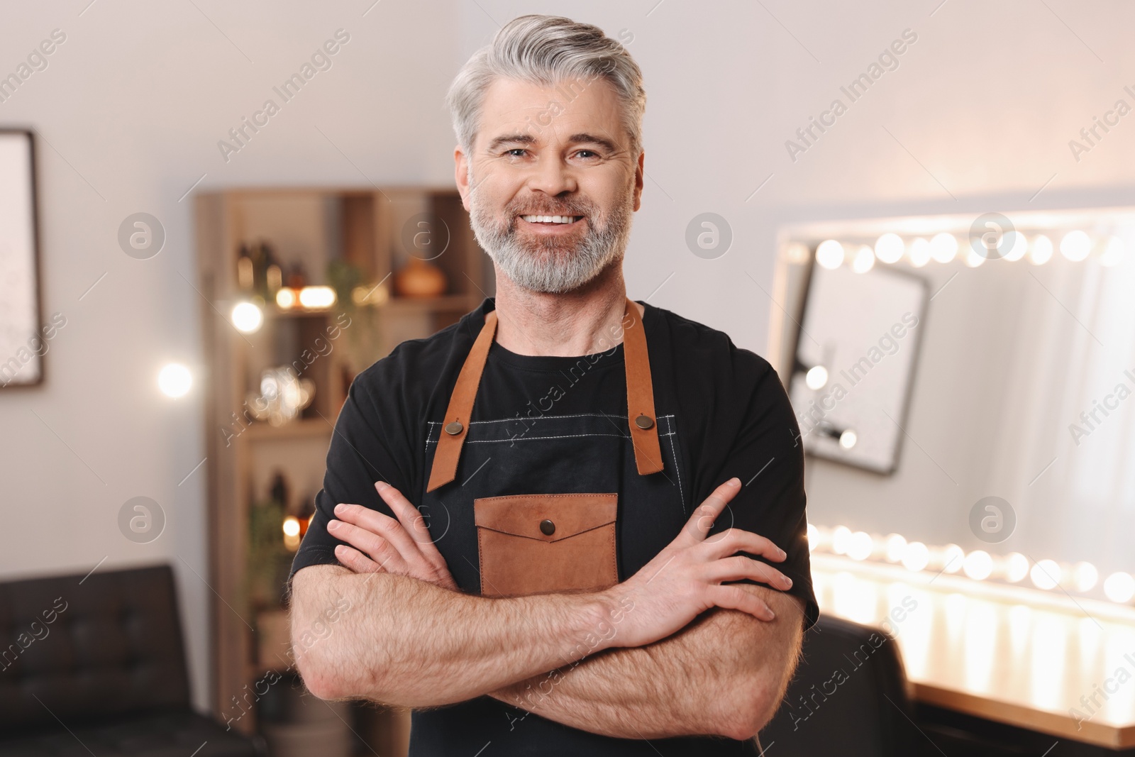 Photo of Portrait of smiling hairdresser in beauty salon