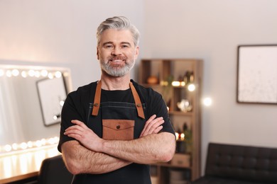 Portrait of smiling hairdresser in beauty salon