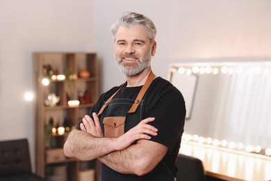 Portrait of smiling hairdresser in beauty salon