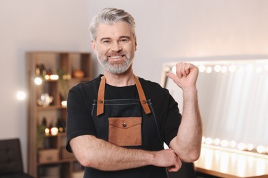 Portrait of smiling hairdresser in beauty salon