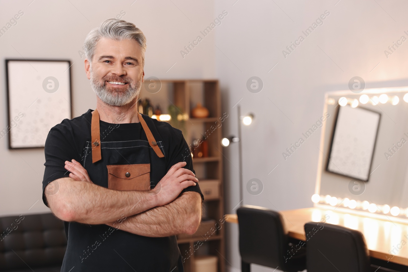 Photo of Portrait of smiling hairdresser in beauty salon, space for text