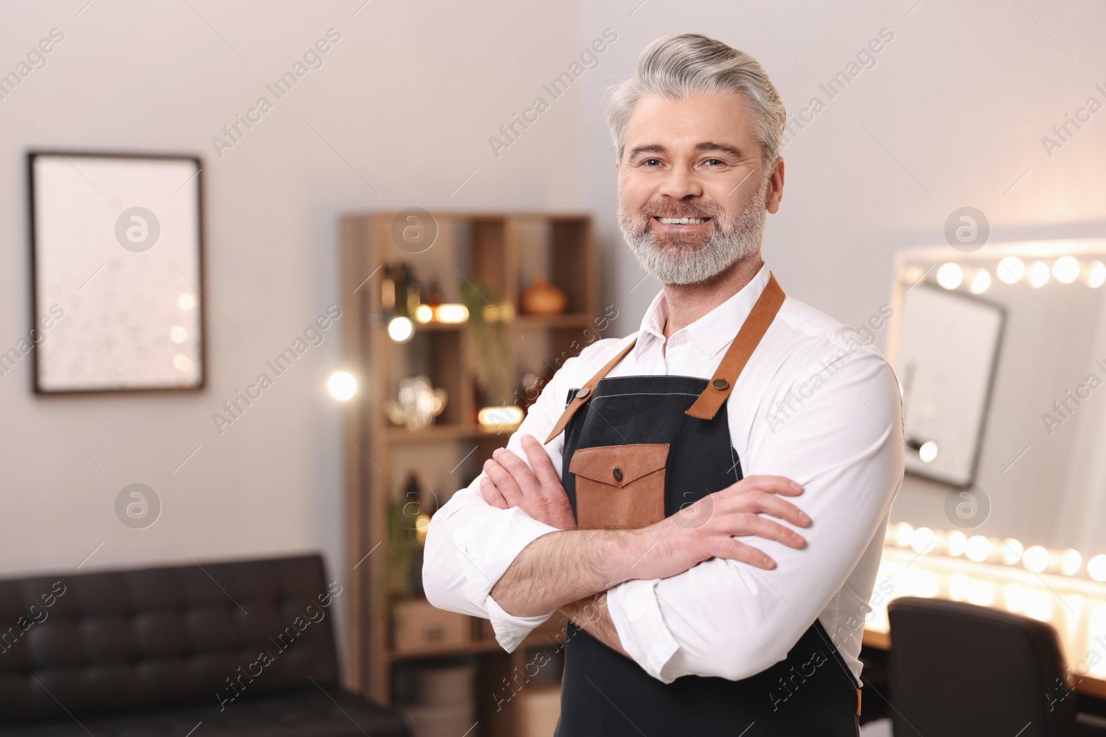 Photo of Portrait of smiling hairdresser in beauty salon, space for text