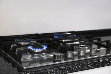 Stove with burners on counter in kitchen