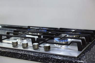 Stove with burners on counter in kitchen