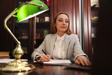 Photo of Notary working with laptop at table in office