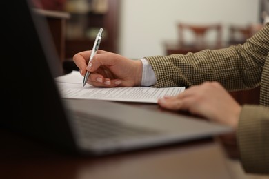 Photo of Notary working at table in office, closeup