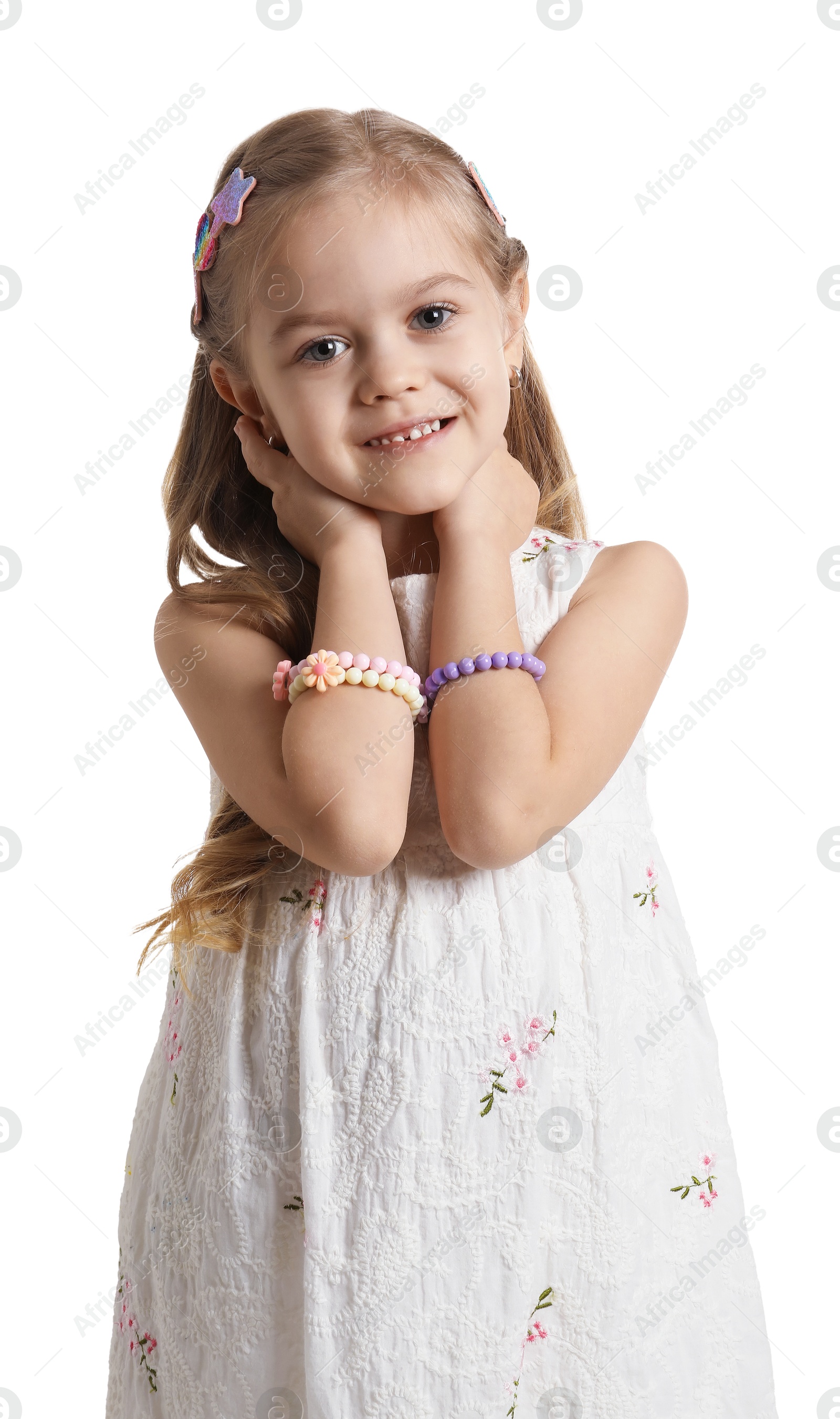 Photo of Cute little girl with beautiful hair clips on white background