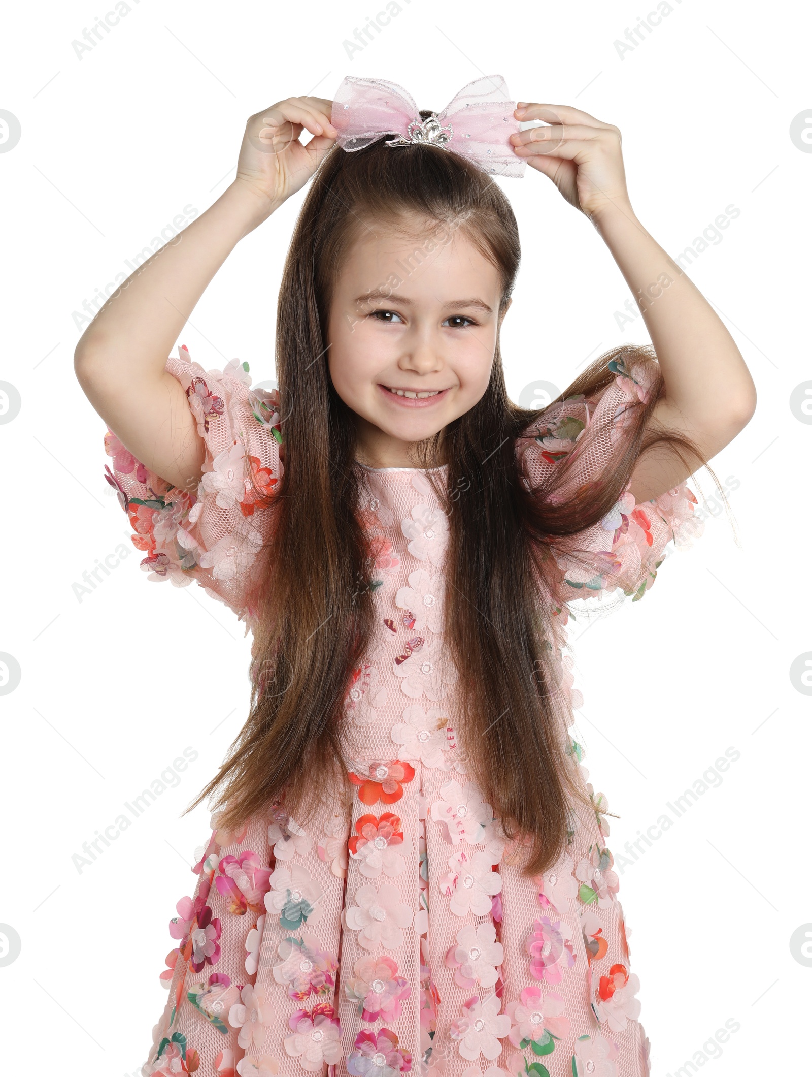 Photo of Happy little girl wearing beautiful hair accessory on white background