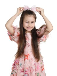 Photo of Happy little girl wearing beautiful hair accessory on white background