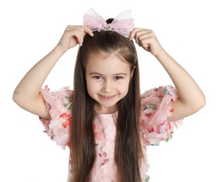 Happy little girl wearing beautiful hair accessory on white background