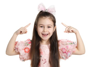 Photo of Happy little girl wearing beautiful hair accessory on white background