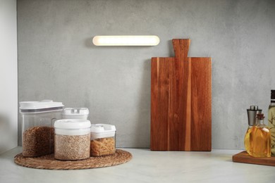 Photo of Glowing modern LED lamp on wall in kitchen