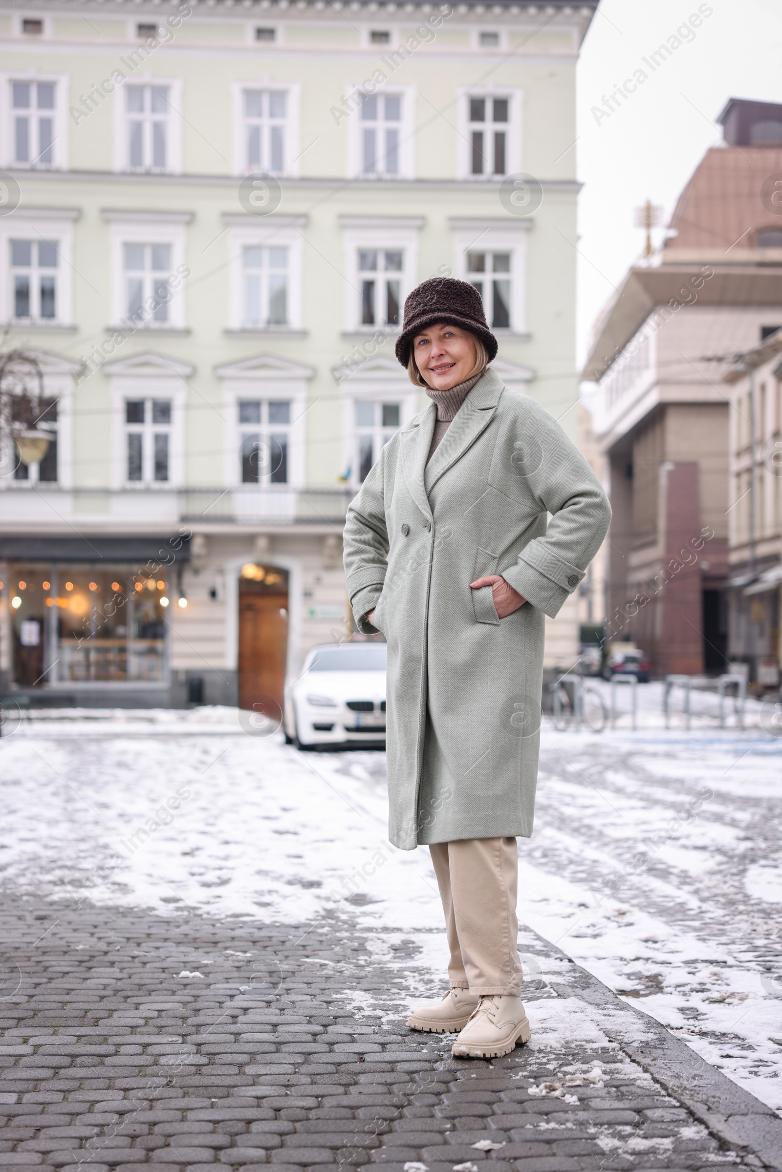 Photo of Smiling senior woman on city street. Space for text