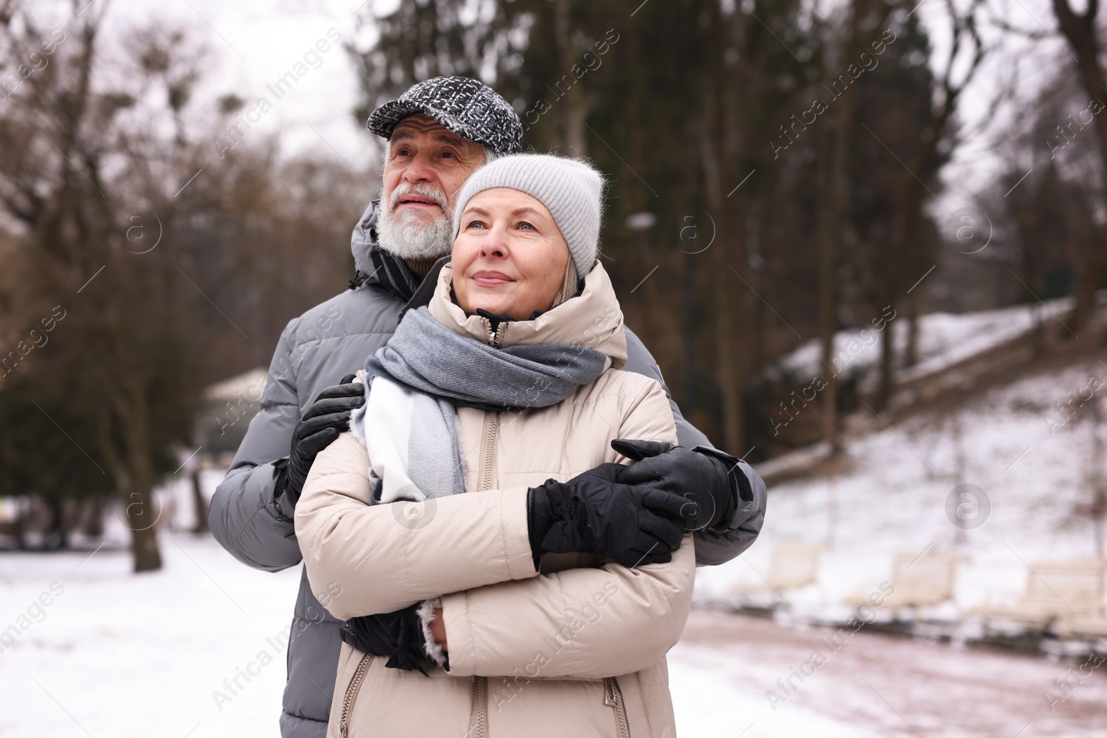 Photo of Lovely senior couple at winter park. Space for text