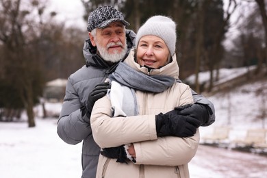 Happy senior couple walking at winter park