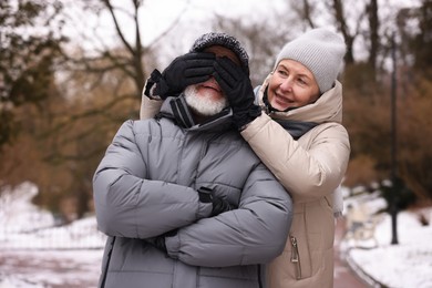 Photo of Happy senior couple having fun at winter park