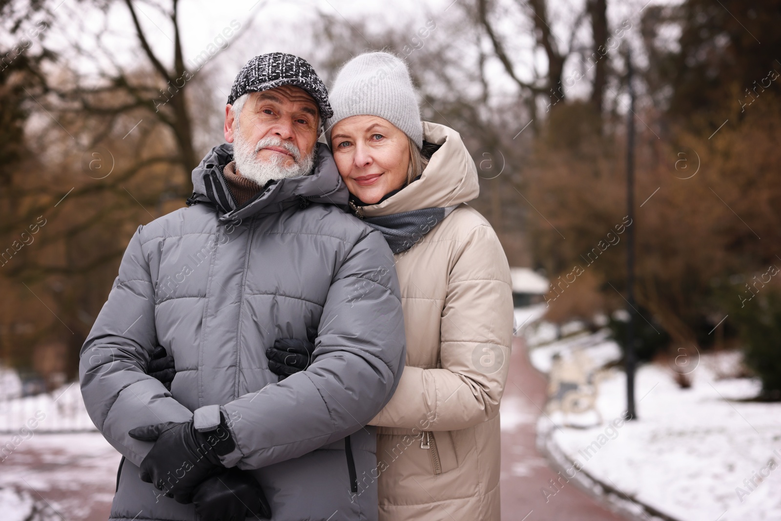 Photo of Lovely senior couple at winter park. Space for text