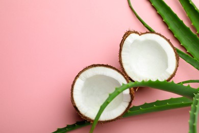 Photo of Hair treatment. Fresh coconut and aloe leaves on pink background, flat lay. Space for text