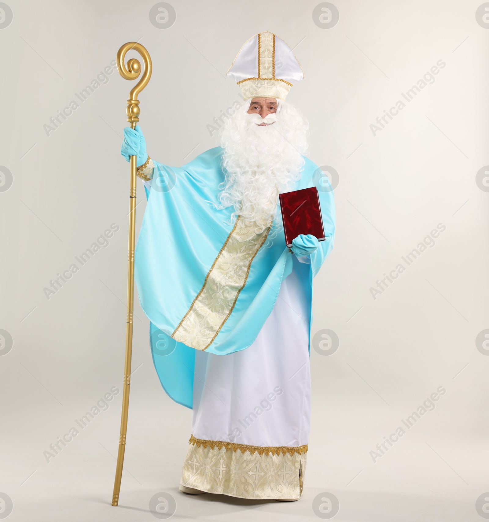 Photo of Saint Nicholas with book and crozier on gray background