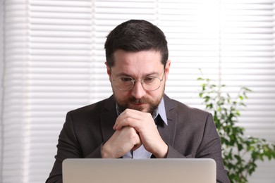 Photo of Online speaker streaming webinar with laptop indoors