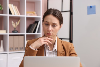 Photo of Online speaker streaming webinar with laptop indoors