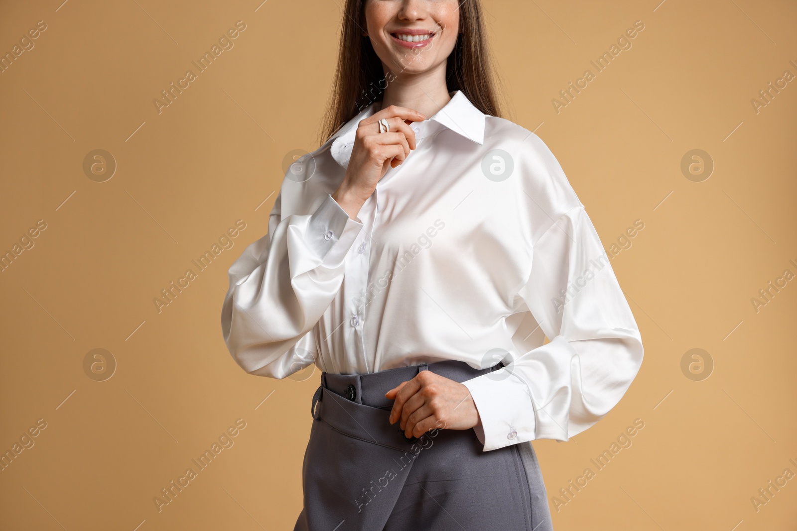 Photo of Beautiful woman in stylish outfit on beige background, closeup