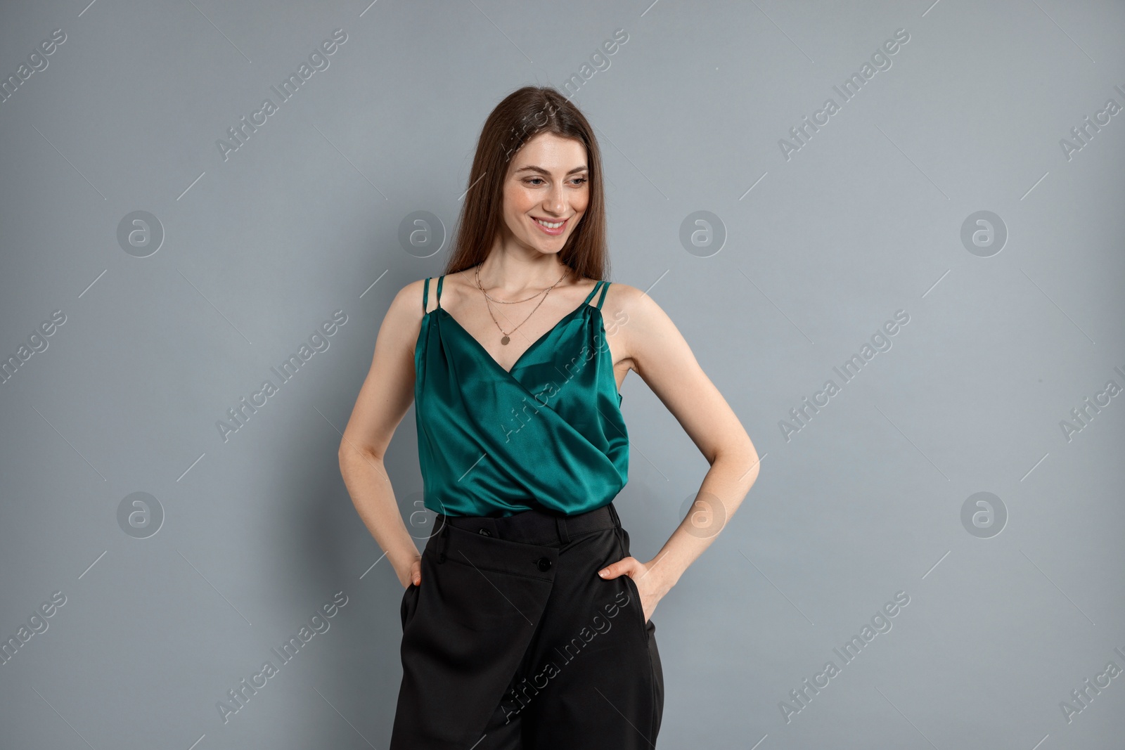 Photo of Beautiful woman in stylish outfit on grey background