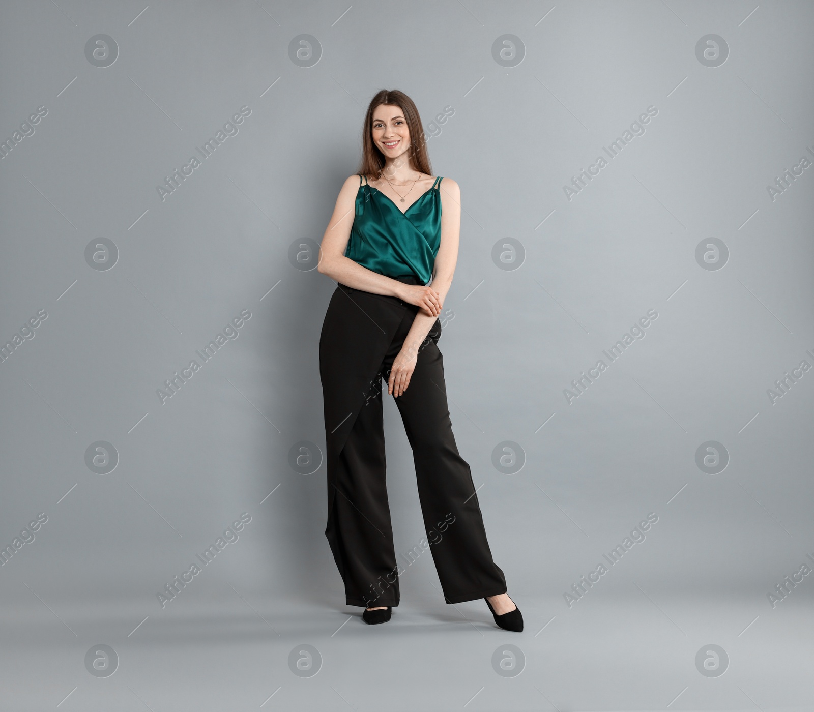 Photo of Beautiful woman in stylish outfit on grey background