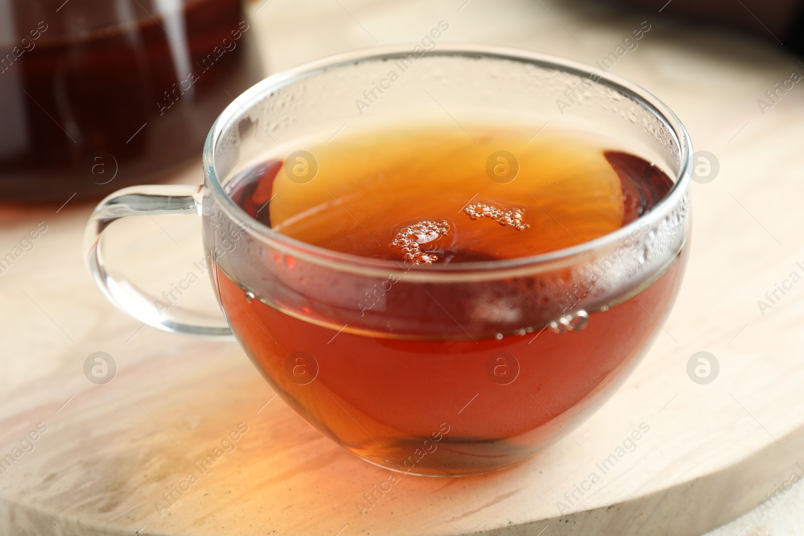 Aromatic tea in cup on light marble board, closeup Photo of Aromatic tea in cup on light marble board, closeup