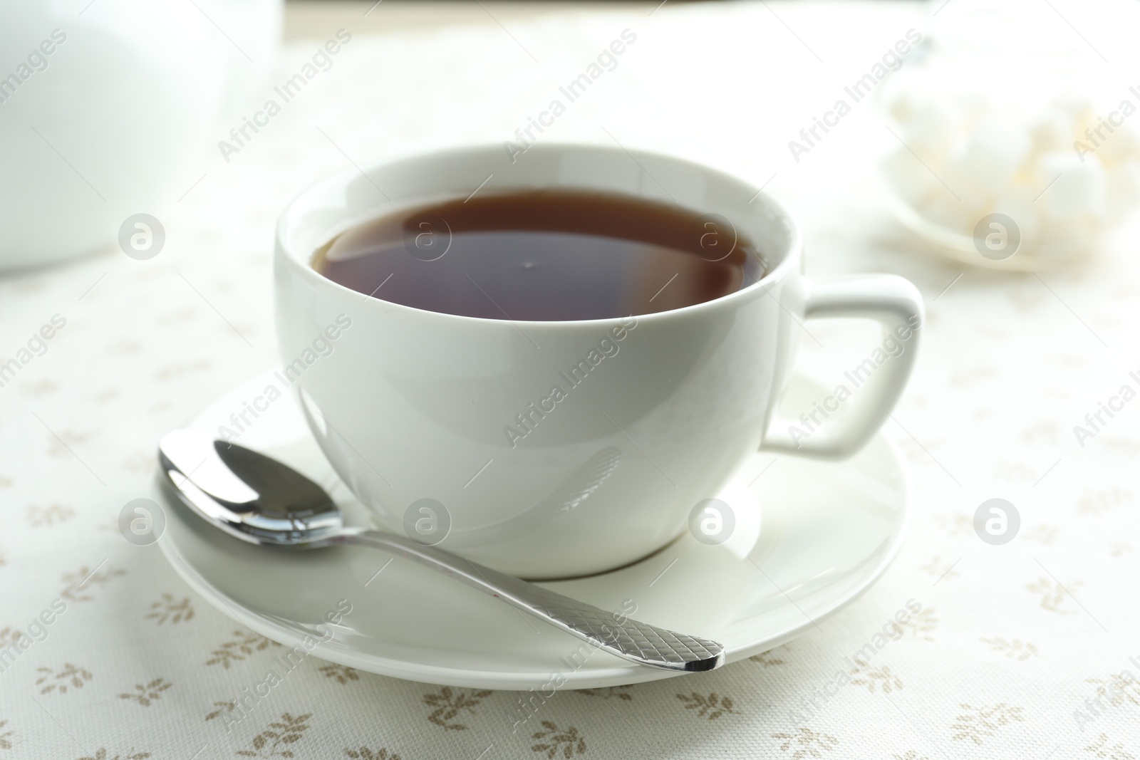 Aromatic tea in cup on table, closeup Photo of Aromatic tea in cup on table, closeup
