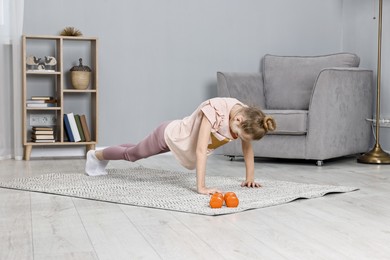 Little girl exercising at home. Morning routine