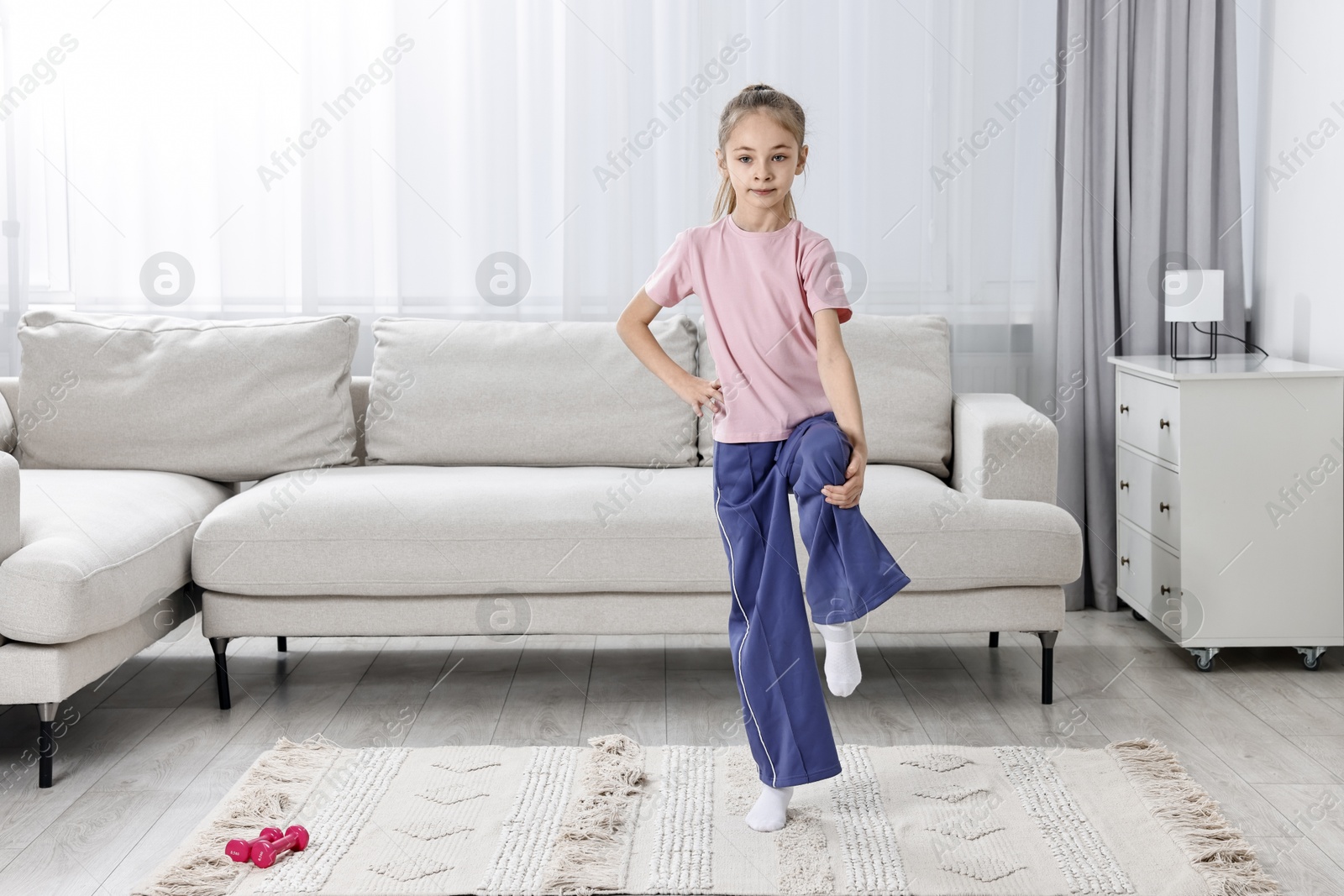 Photo of Little girl exercising at home, space for text. Morning routine