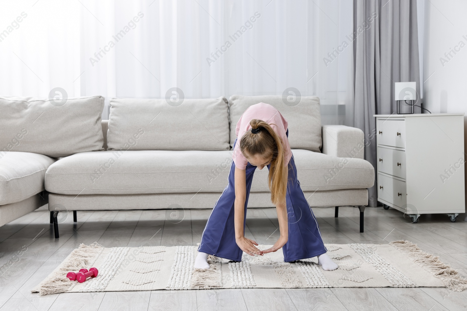 Photo of Little girl exercising at home, space for text. Morning routine