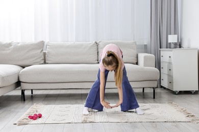 Photo of Little girl exercising at home, space for text. Morning routine