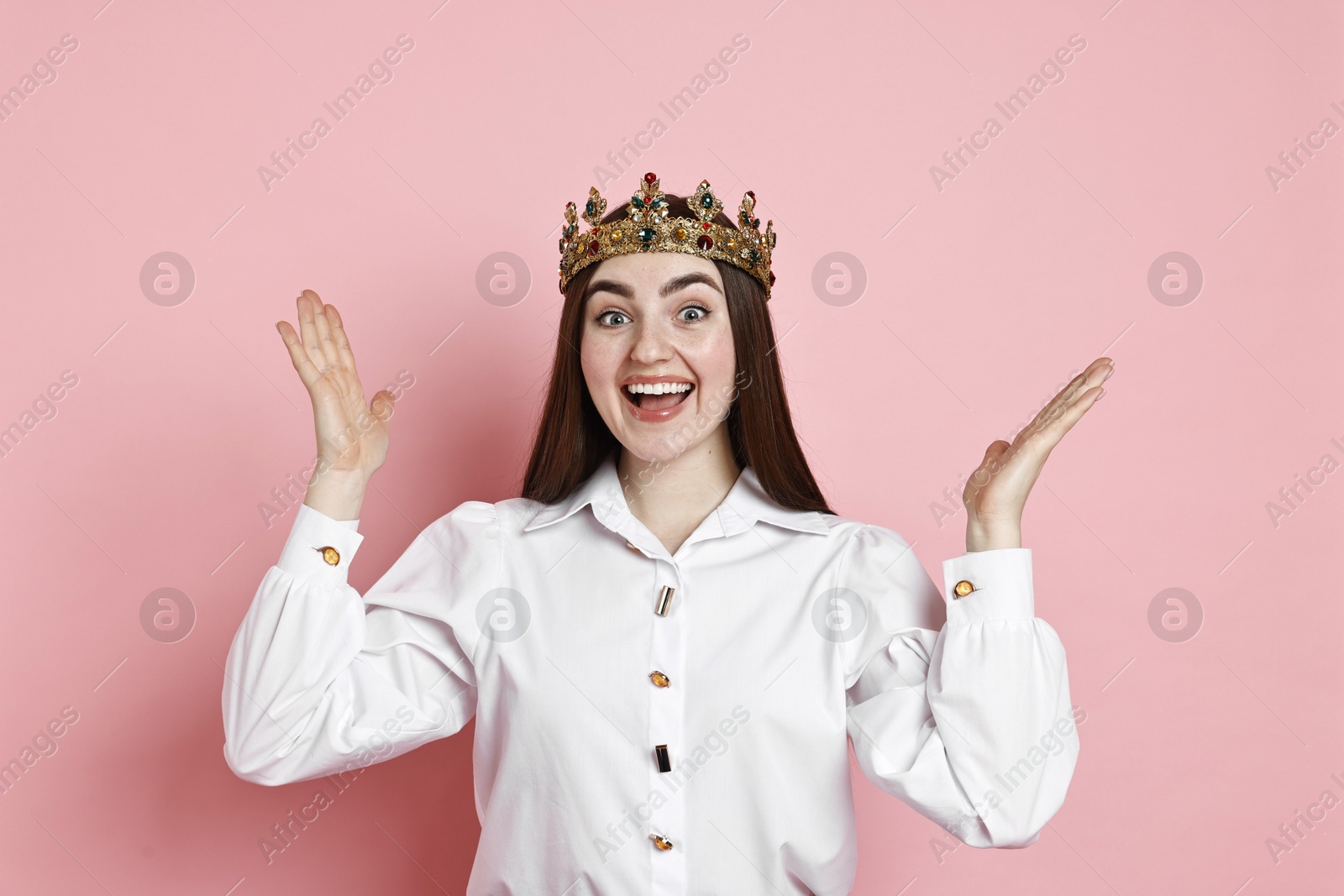 Photo of Happy woman in elegant crown on pink background