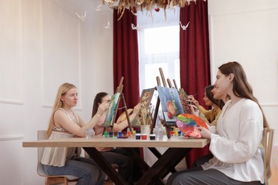 Photo of Group of women learning to draw at table in class