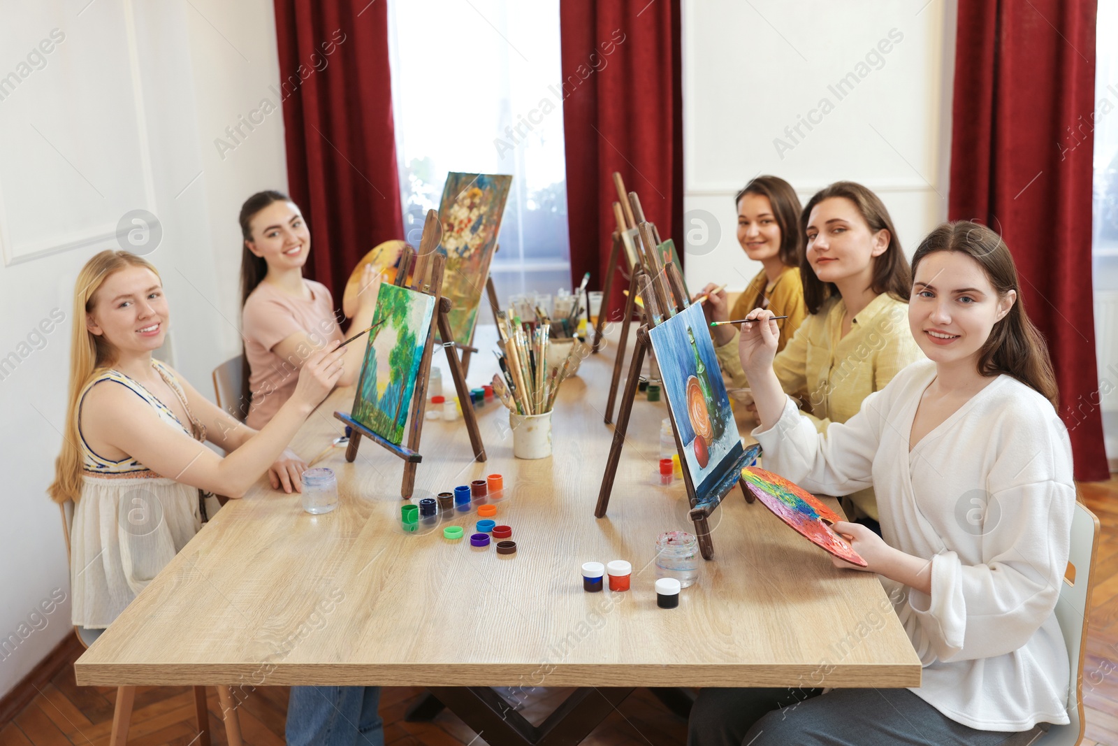 Photo of Group of women learning to draw at table in class