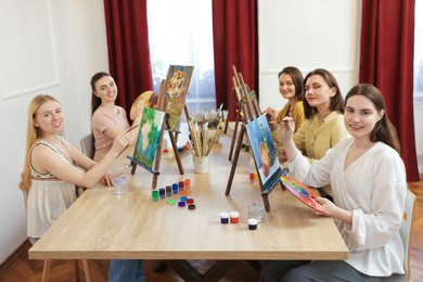 Group of women learning to draw at table in class